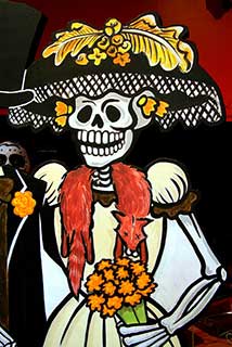 La Catrina illustriert als Skelett mit Kleid und Hund